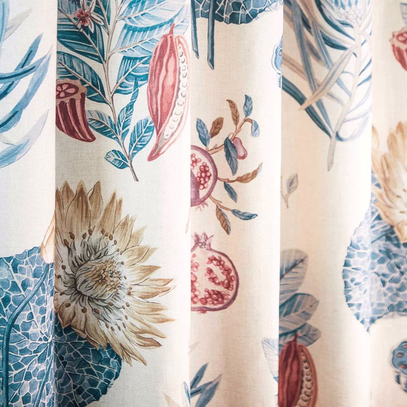 Patterned fabric in a close-up with soft vertical folds, made up as curtains.