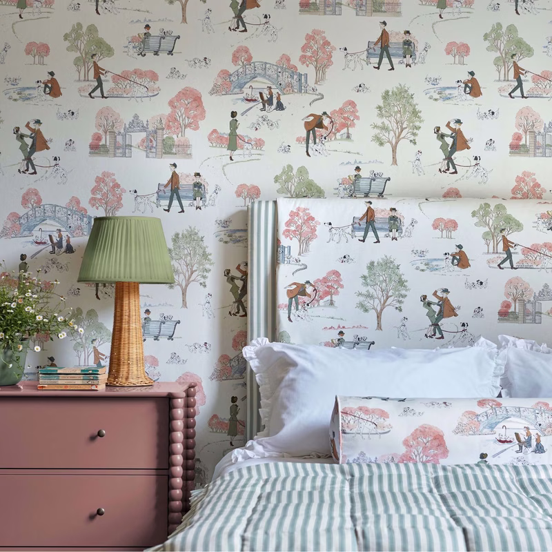 Bedroom with 101 Dalmatians wallpaper and the fabric made up as a bolster cushion on the bed.