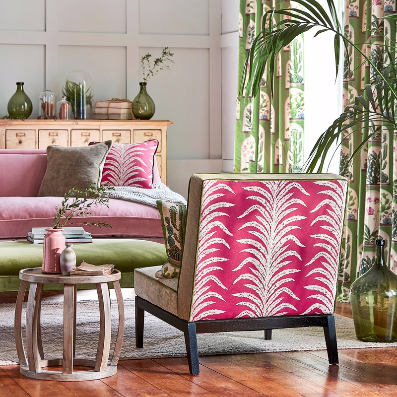 A bright living room with the Tree Fern Weave fabric shown on an upholstered armchair, with matching curtains and a cushion visible.