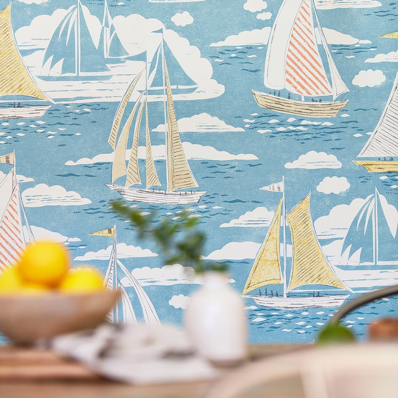 Patterned wall fabric with sailing boats and clouds, shown as a flat length of cloth.