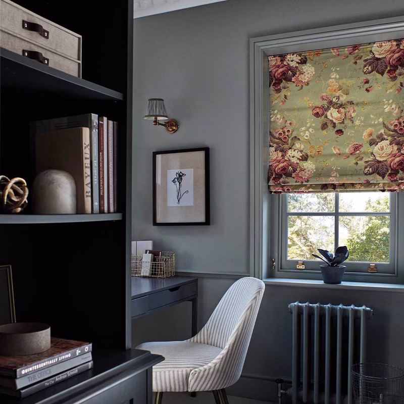 Grey home office with a floral patterned Roman blind at the window.