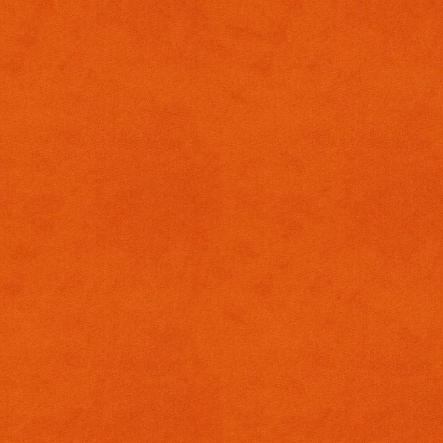 Warm burnt-orange fabric with subtle cloudy tonal variation across its plain surface