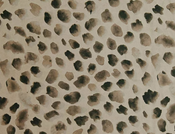 Warm stone textile with scattered charcoal, olive and taupe painterly spots