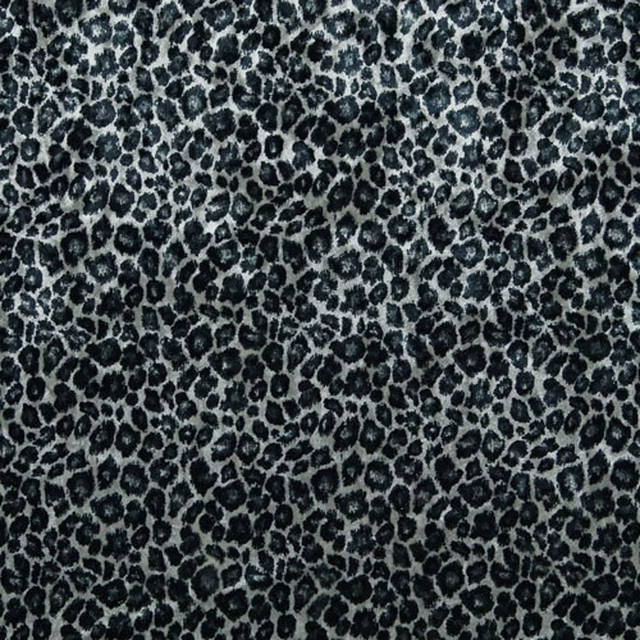 Cool grey textile with dense charcoal leopard rosettes and a softly brushed surface