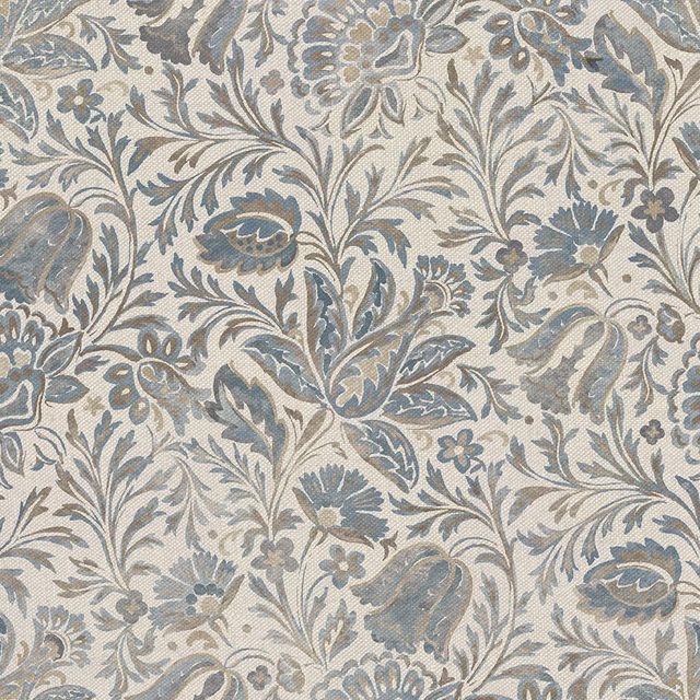Weathered blue floral and paisley motifs woven over a warm cream ground