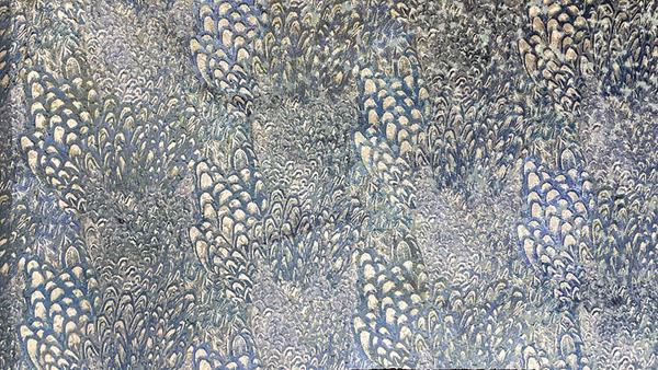 Muted blue-grey fabric with pale clustered botanical motifs and a richly textured surface