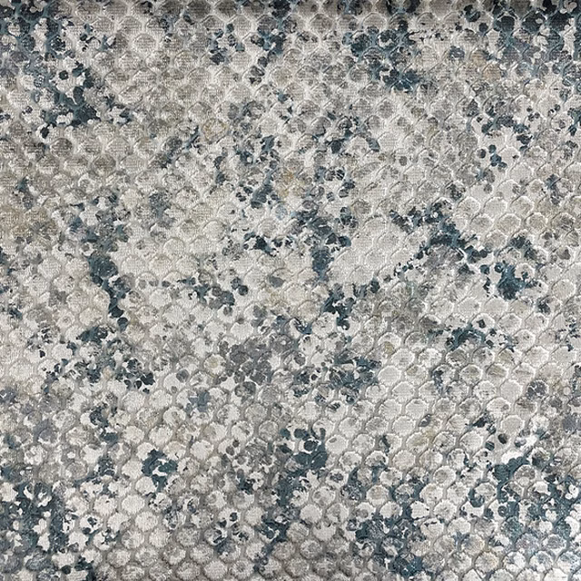 Mottled grey-blue textile with small looping motifs and a softly raised surface