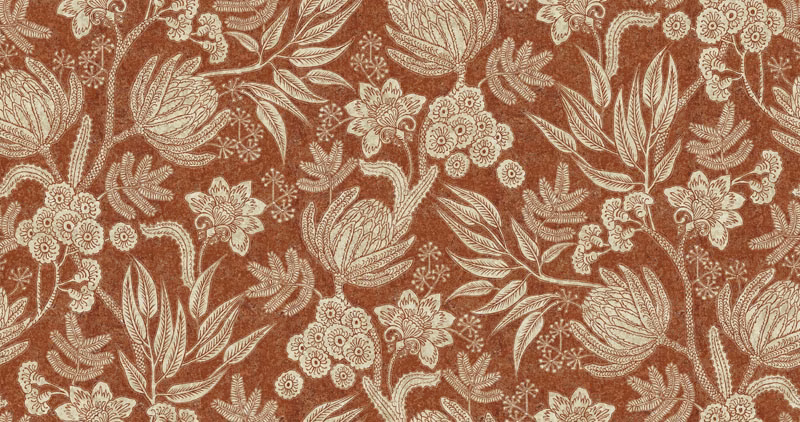 Terracotta floral fabric with ivory leaves, blossoms and a softly textured ground