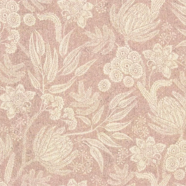 Dusty blush pink woven fabric with ivory trailing flowers, leaves and clustered botanical motifs