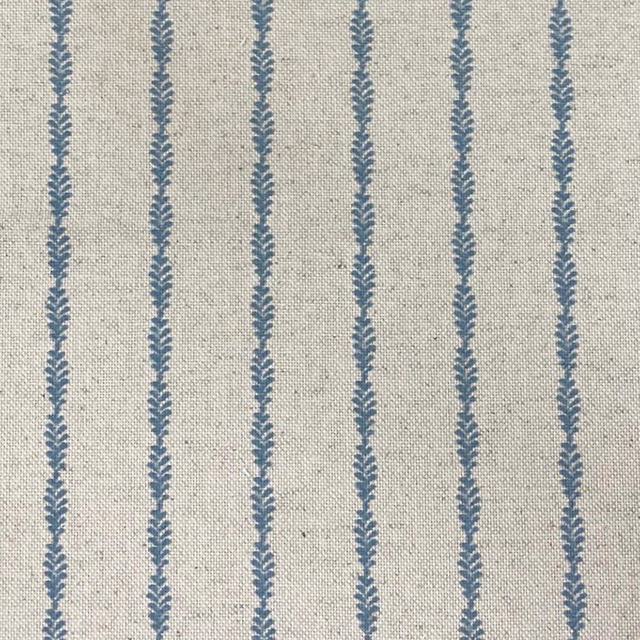 Oatmeal woven ground with evenly spaced blue-grey leafy vertical stripes