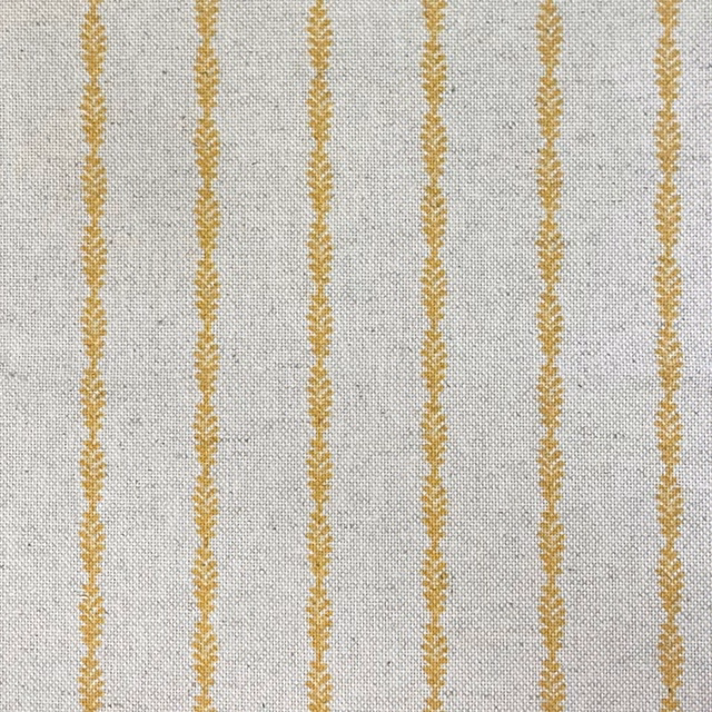 Pale grey woven fabric with muted gold vertical lozenge motifs and fine texture
