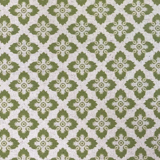 Muted citron-olive ornamental motifs on a textured ivory woven fabric