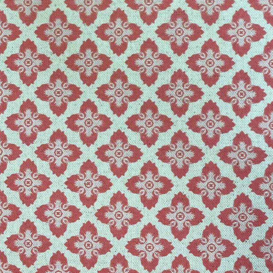 Mint-aqua woven fabric with repeating melon-red floral medallions and cream scrollwork