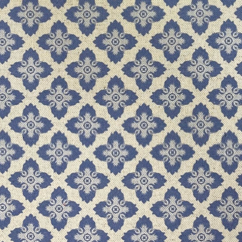 Warm cream woven ground with repeating slate-blue ornamental medallions and tactile texture