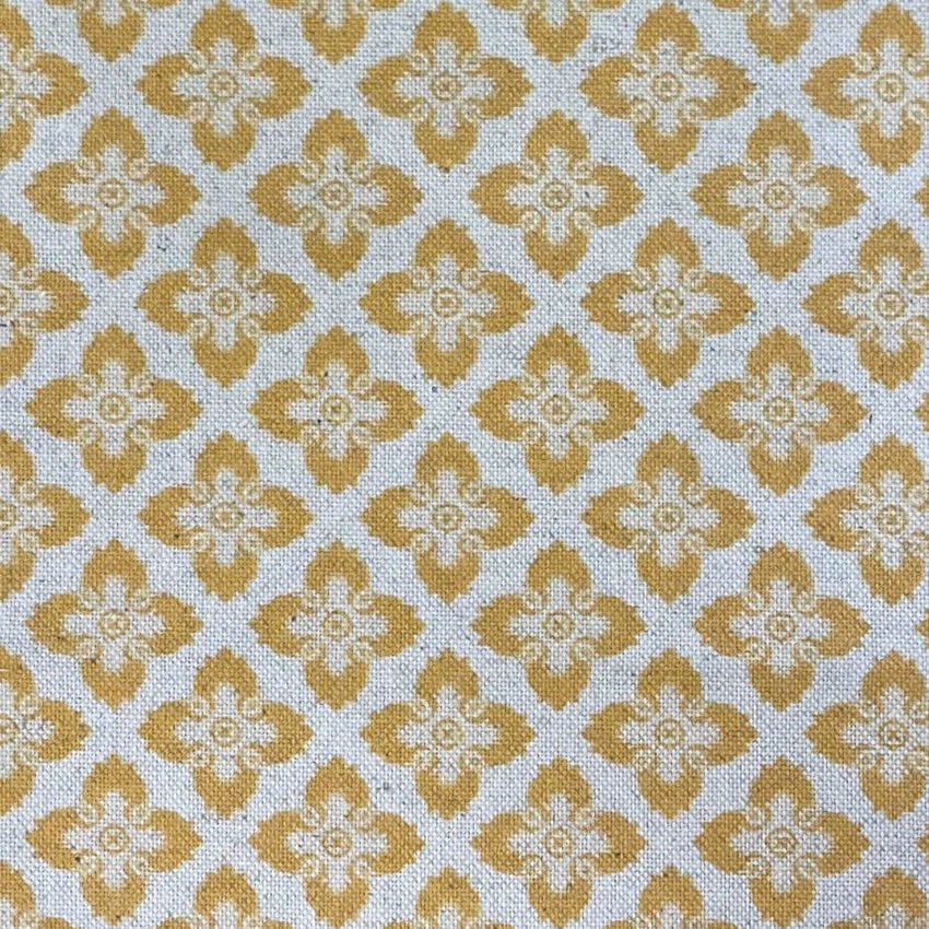 Muted spring-gold quatrefoils on a pale blue-grey woven textile
