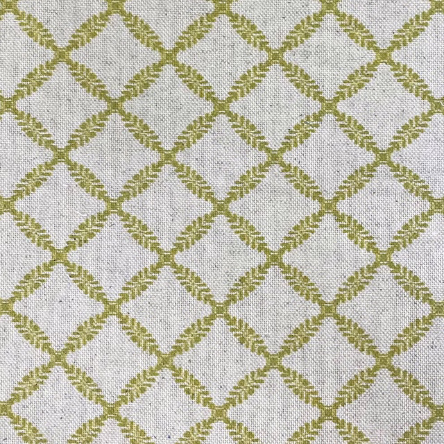 Pale neutral woven fabric with muted kiwi-green diamond trellis and tactile grain