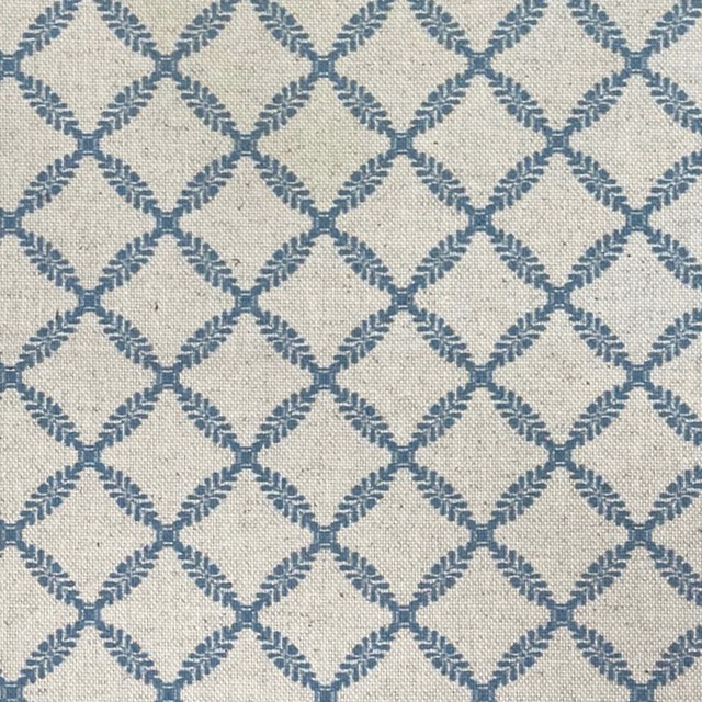 Ivory woven fabric with a cool blue diamond lattice and gently slubbed texture