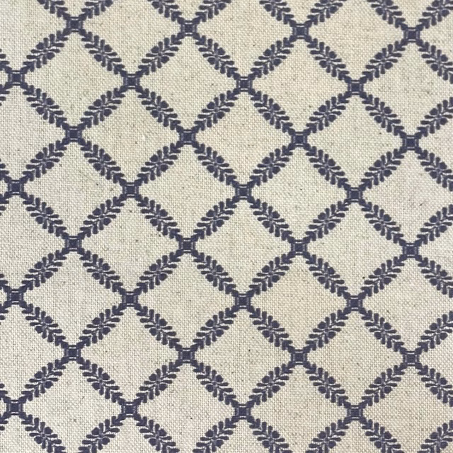 Pale cream woven ground with dark ink-navy leafy diamond trellis pattern