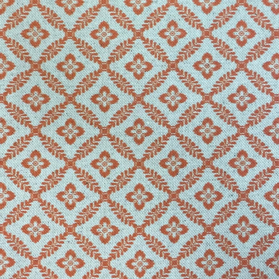 Pale aqua woven fabric with terracotta diamond trellis and small floral motifs