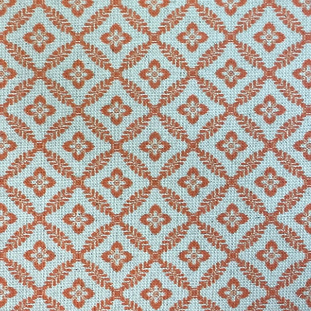 Pale aqua woven fabric with terracotta diamond trellis and small floral motifs