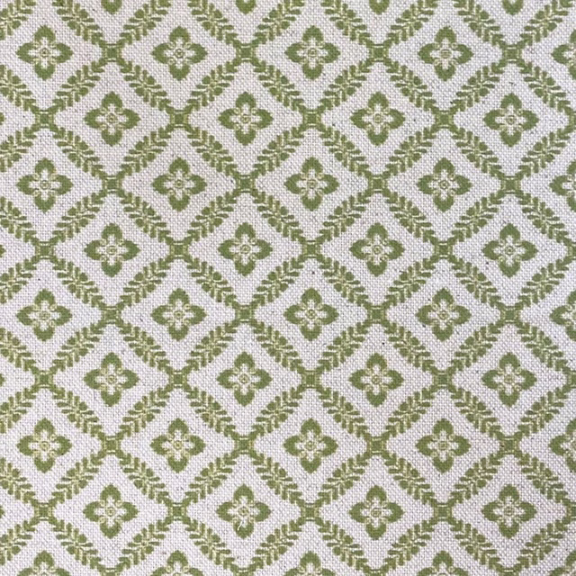 Muted olive-green diamond lattice with cream quatrefoil motifs on a woven ground
