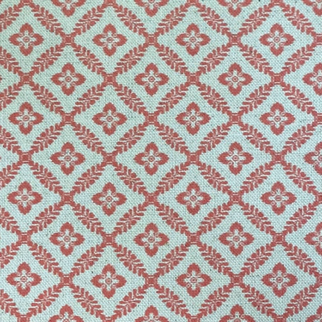 Pale aqua woven ground with coral melon diamond trellis and quatrefoil motifs