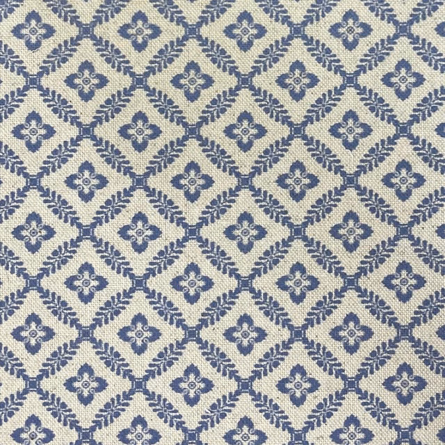 Cream woven textile with muted navy diamond lattice and small floral medallions