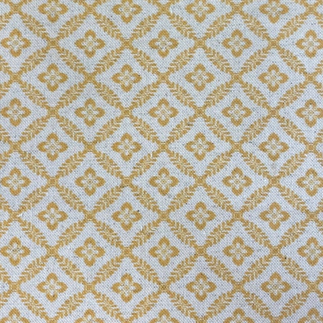 Muted spring-gold diamond lattice with quatrefoils on a pale blue-grey textured weave