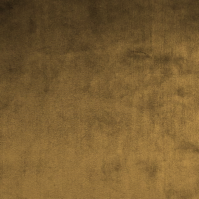 Muted ochre-gold woven fabric with irregular brown clouded shading and fine texture