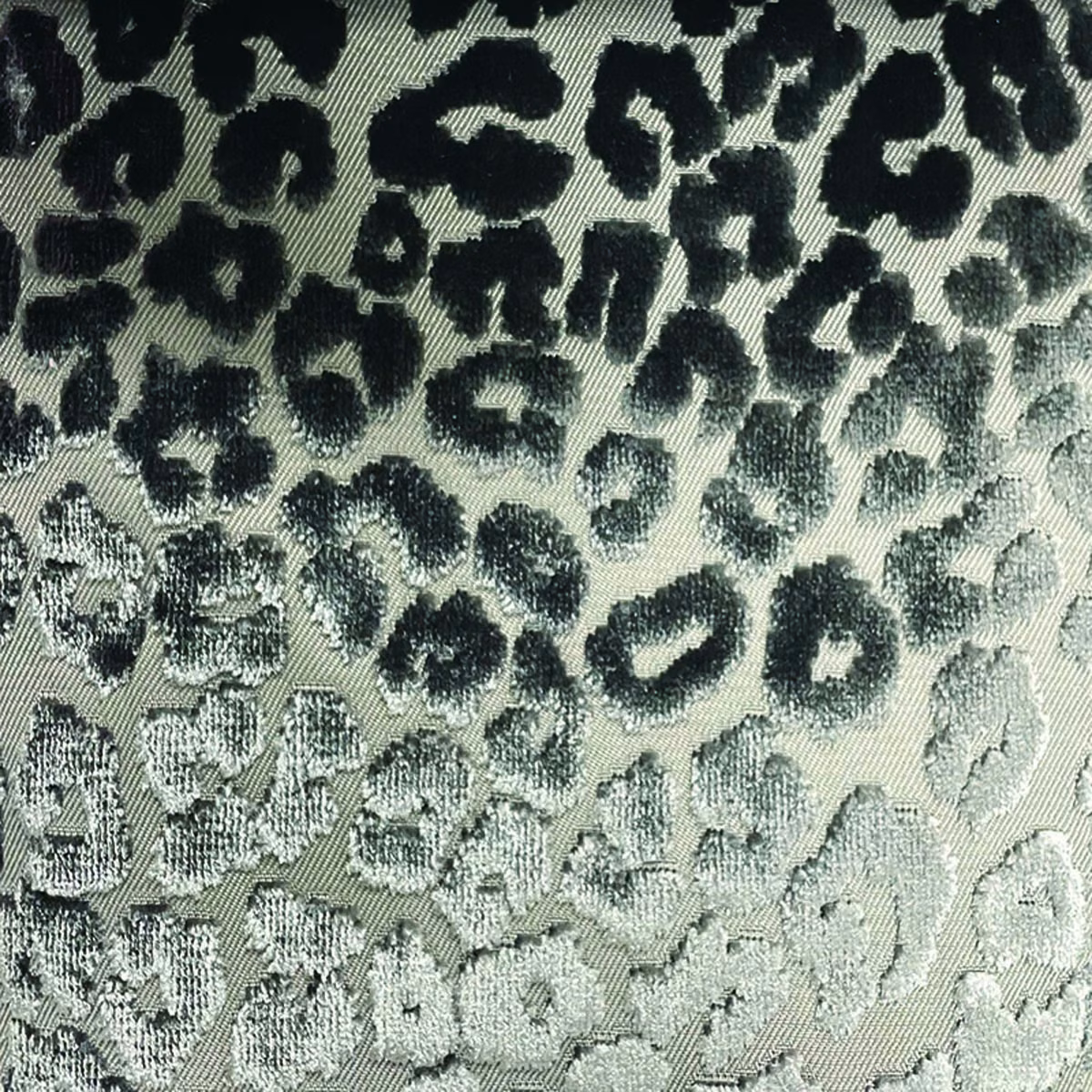 Pale sage woven fabric with irregular black cheetah spots and tactile diagonal texture