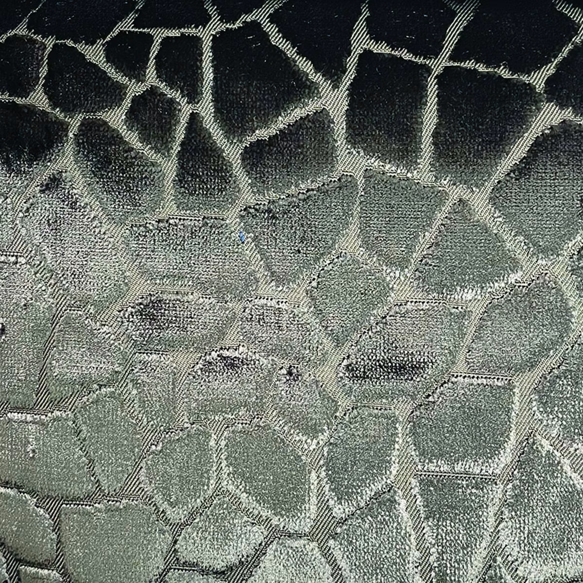Smoky sage and charcoal woven fabric with large irregular mosaic shapes and textured edges