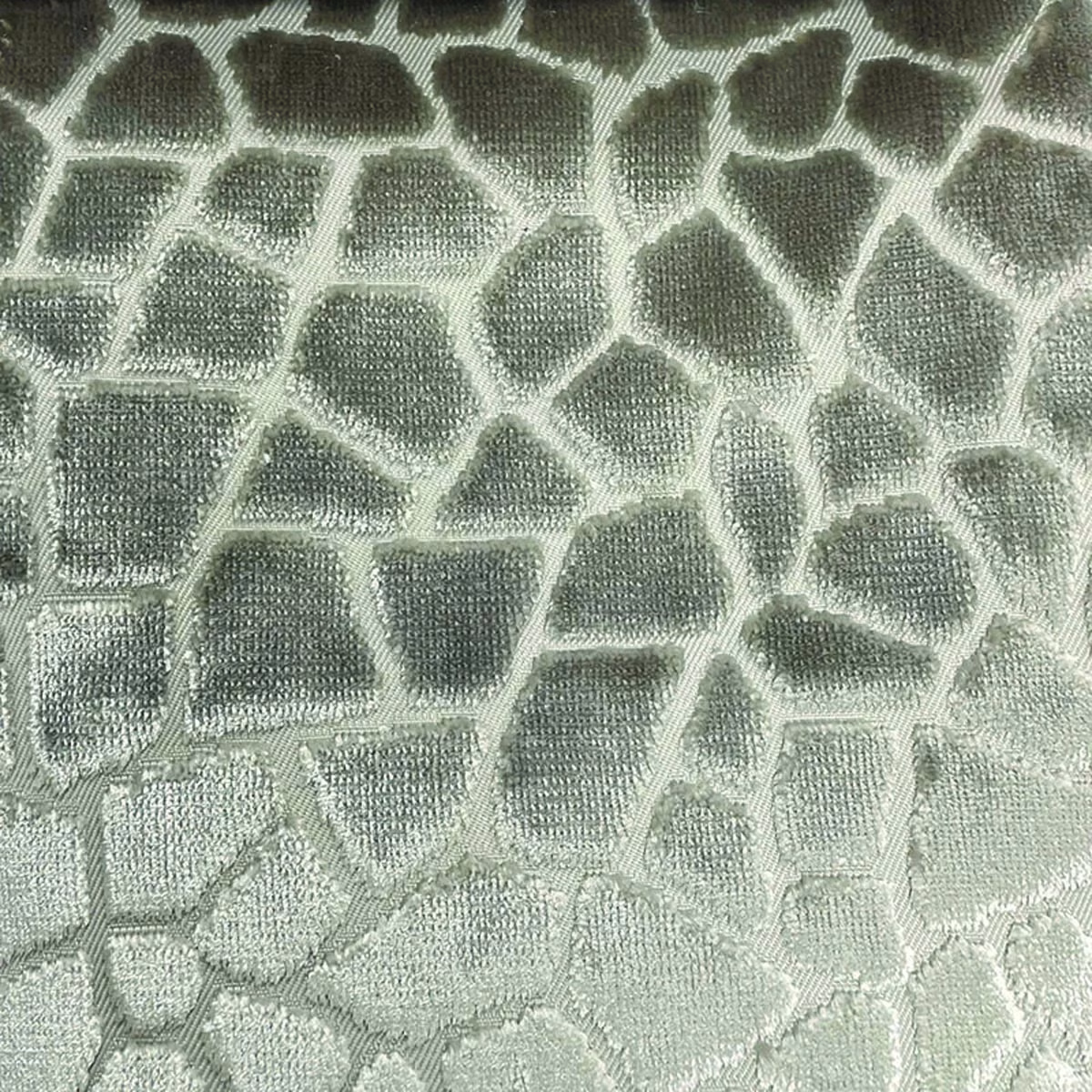 Sage-grey woven textile with irregular pale mosaic cells and raised texture