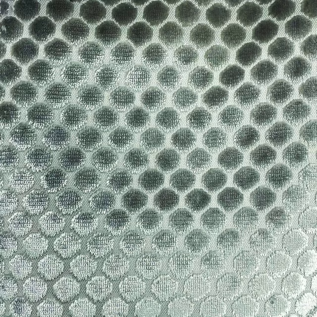 Silvery sage woven fabric with charcoal pebble spots and a tactile honeycomb repeat