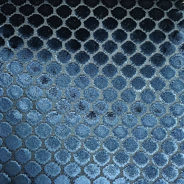 Close-up of navy and denim-blue rounded spots in a shimmering lattice weave