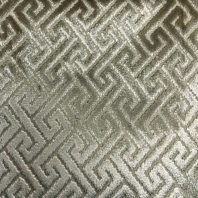 Muted sage-grey woven fabric with raised interlocking trellis lines and soft sheen