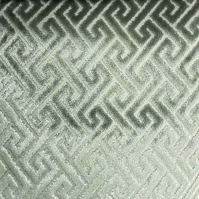 Pale sage-grey woven fabric with raised angular trellis pattern and tactile texture