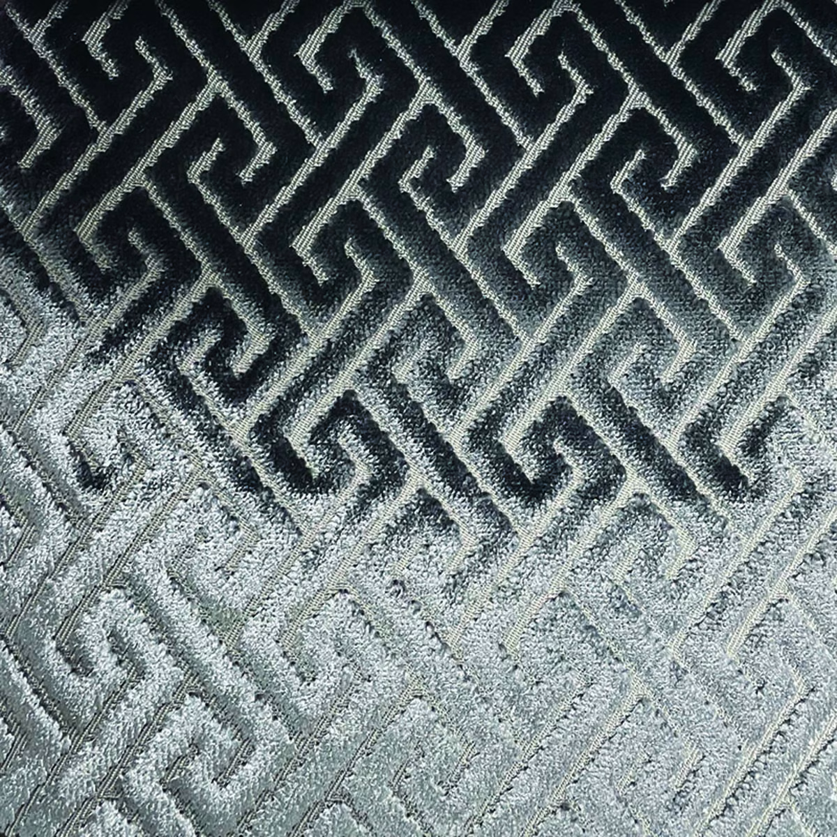 Black-to-silver woven trellis with interlocking Greek-key lines and tactile texture
