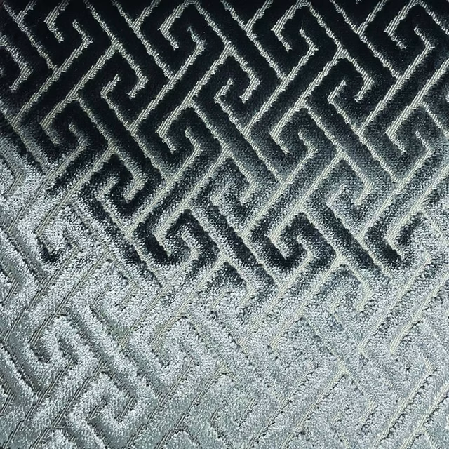 Black-to-silver woven trellis with interlocking Greek-key lines and tactile texture