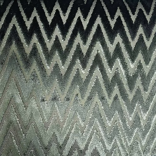 Charcoal and sage-grey zigzags with pale chevrons in a mottled woven texture
