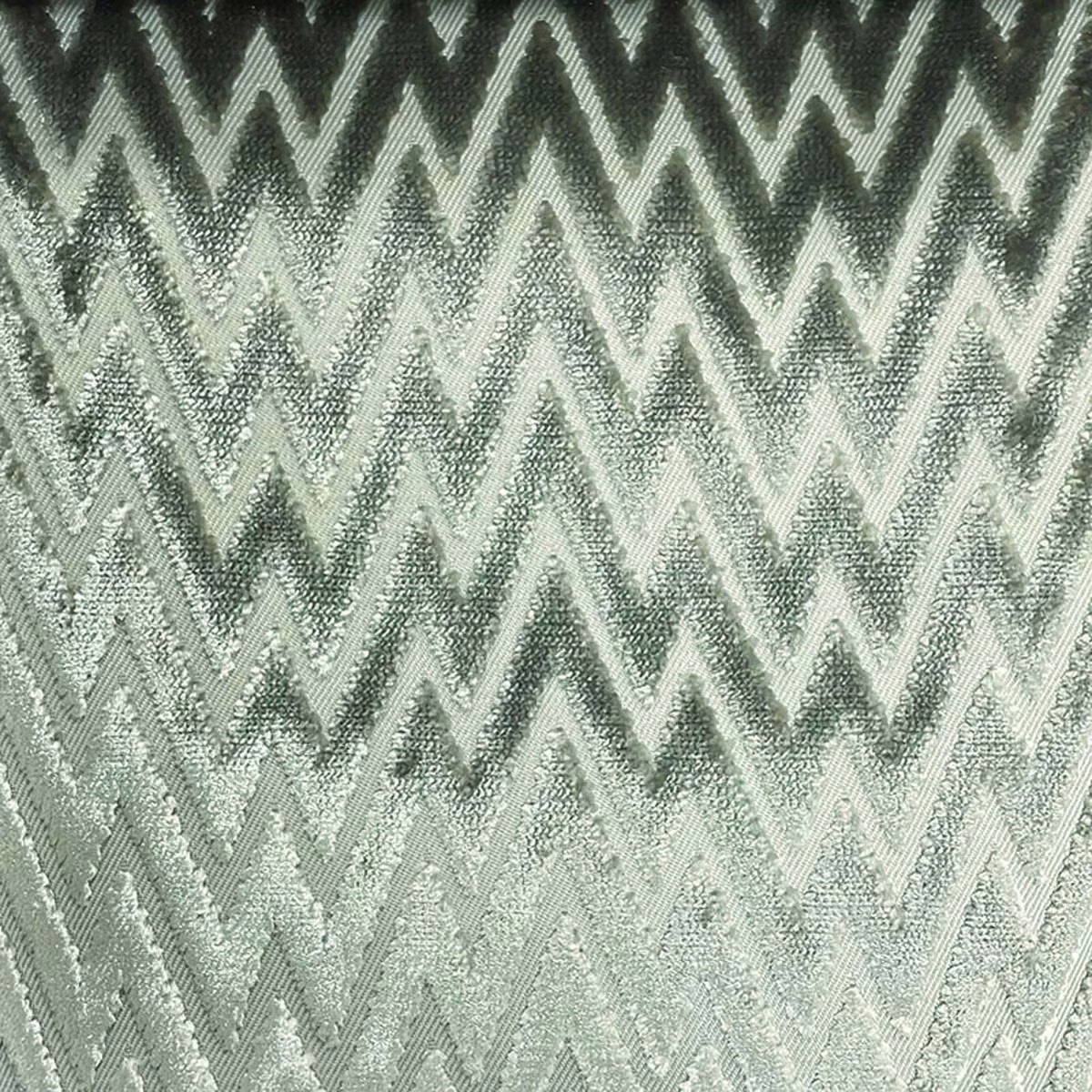 Pale sage-grey woven textile with charcoal zigzags and a softly nubby surface