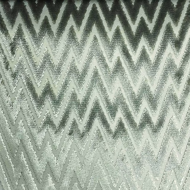 Pale sage-grey woven textile with charcoal zigzags and a softly nubby surface