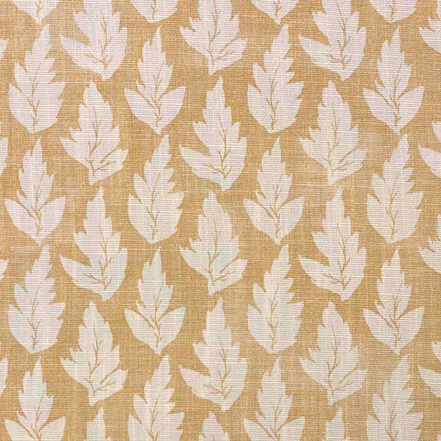 Ochre woven fabric with repeating ivory leaf motifs and subtle crosshatched texture