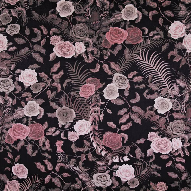 Black textile with dusty rose blooms, blush roses and sweeping fern fronds