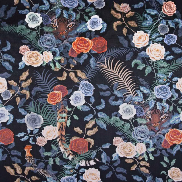 Midnight floral textile with blue roses, coral blooms, tropical leaves and tiger motifs