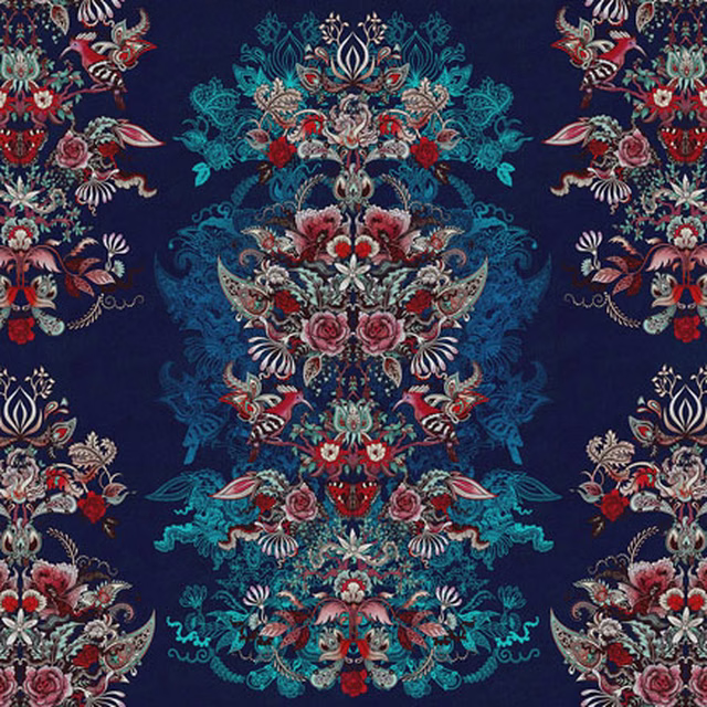 Large symmetrical floral medallions in teal, red and cream on a deep navy ground