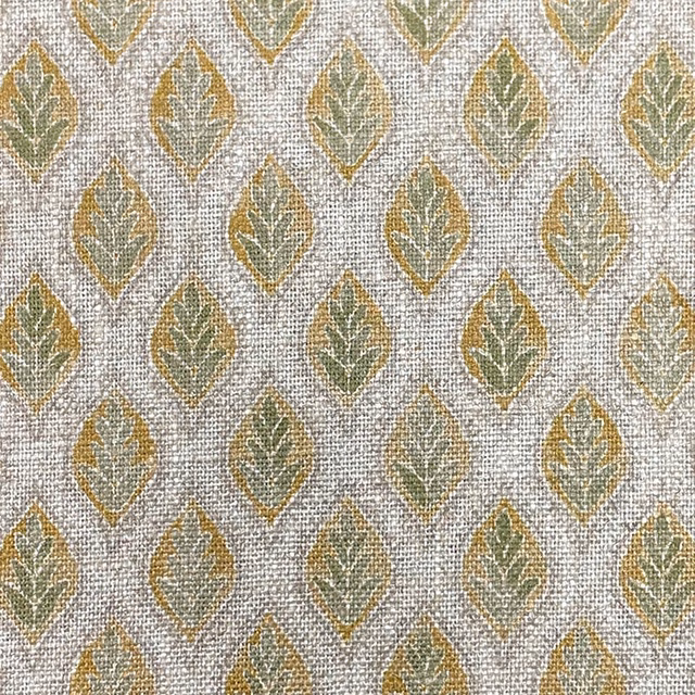 Textured pale woven fabric with repeating sage and ochre leaf motifs