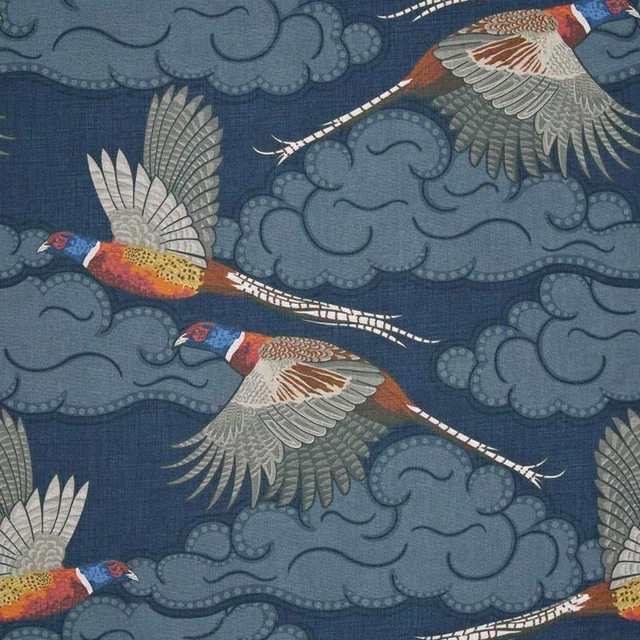 Slate-blue pheasants with rust, cream and grey feathers among curling cloud motifs