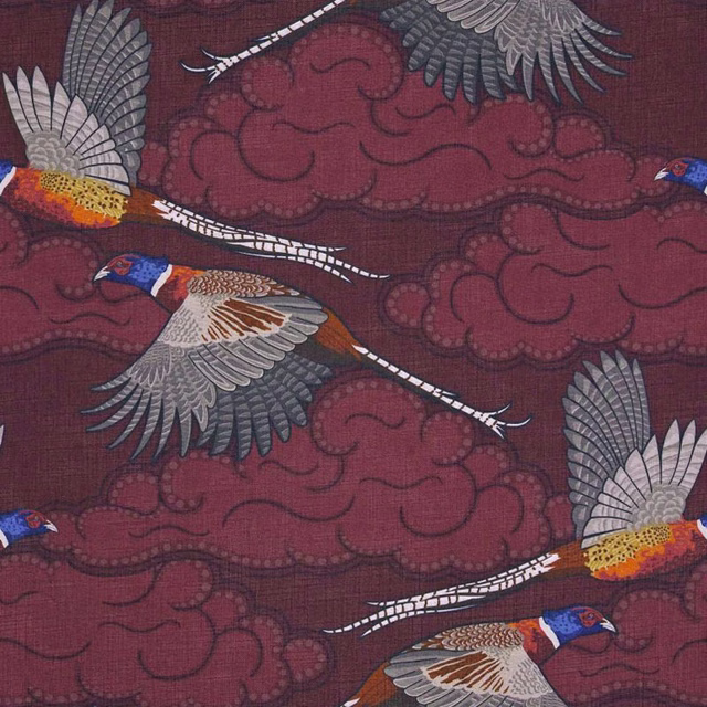 Deep burgundy fabric with flying pheasants, pale feathers and scrolling cloud motifs