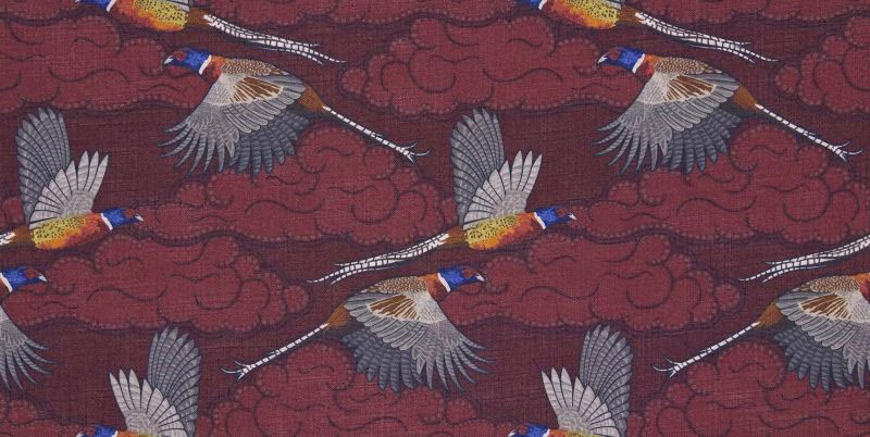 Deep burgundy woven ground with flying birds, pale wings, ochre and blue details
