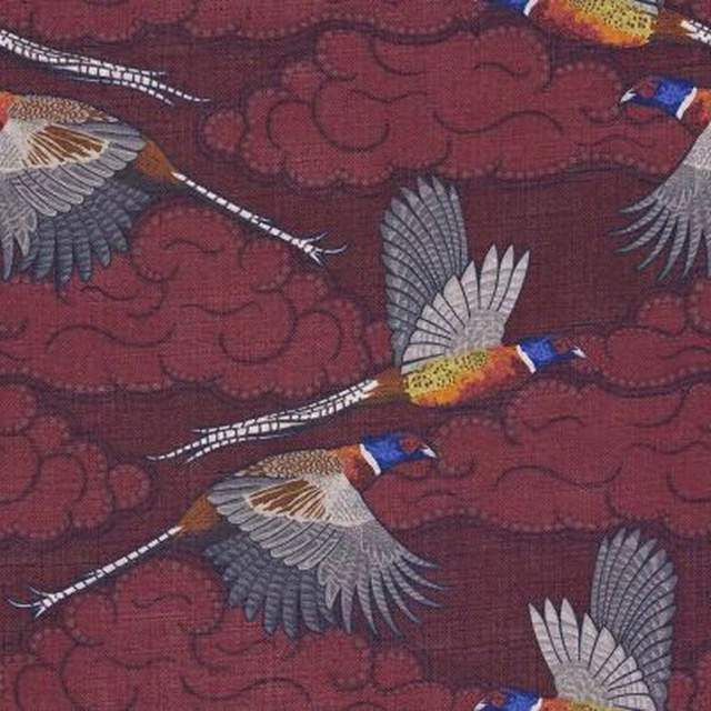 Deep burgundy woven ground with flying birds, pale wings, ochre and blue details